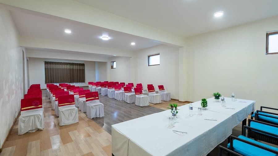 The image shows a well-lit conference room with a long table and chairs arranged for a meeting  | DLS Serenity Resort and Spa
